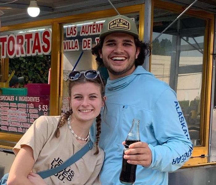 Charlie and young lady in front of a food truck in MExico