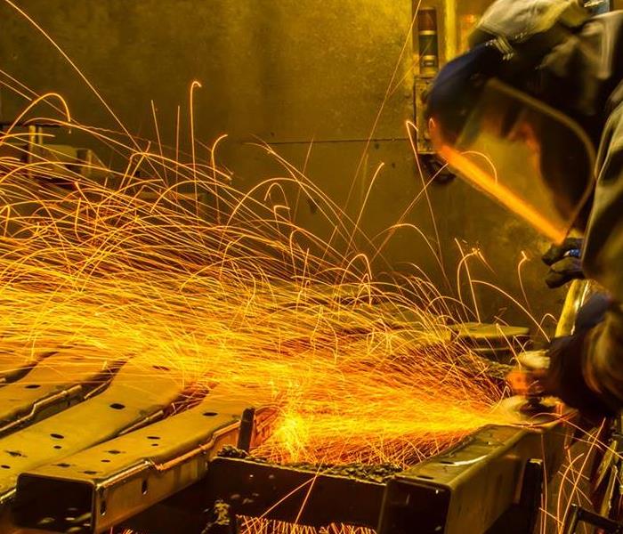 Man grinding metal causing sparks