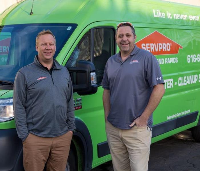 Ted and Randy in front of two green SP vans