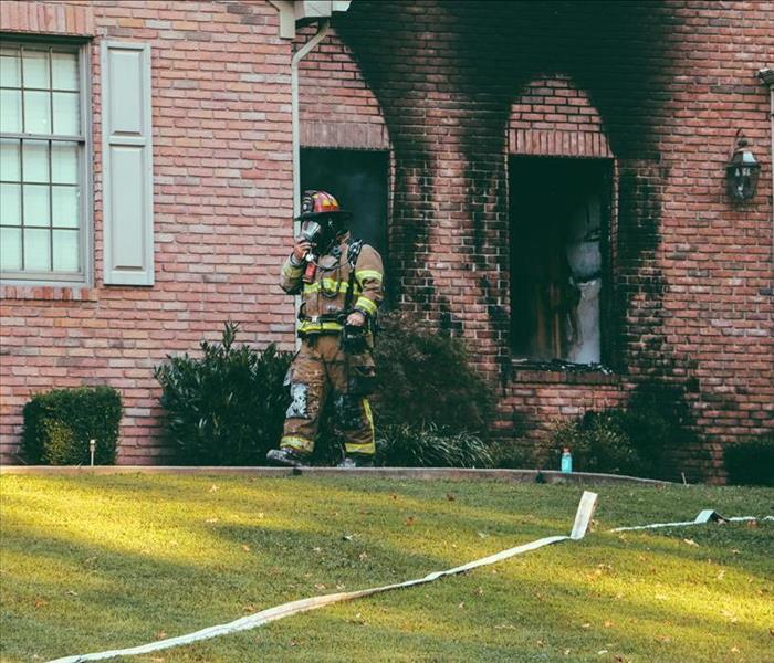 Firefighter outside house