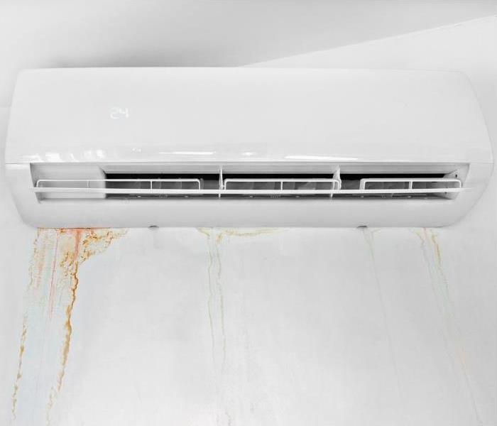 A leaking overhead AC unit on a wall.